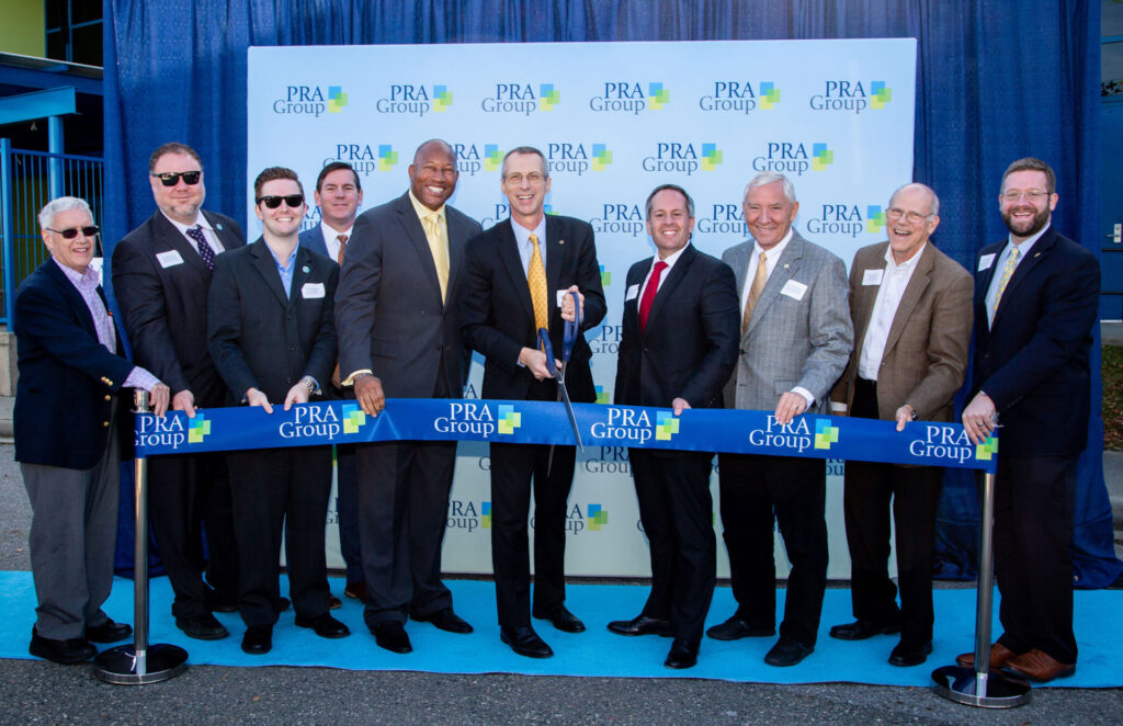 PRA Group celebrates expansion into Danville, VA. Group cutting ribbon.