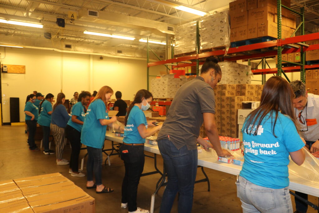 PRA employees volunteering at Foodbank packaging up donated food.