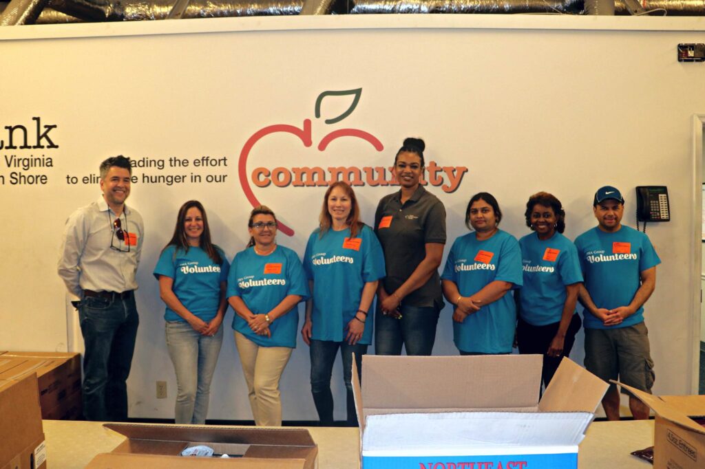 PRA employees post together while volunteering with Foodbank.