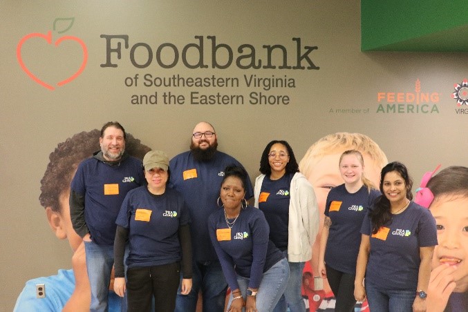 A group of seven volunteers smiling at the Foodbank of Southeastern Virginia and the Eastern Shore.