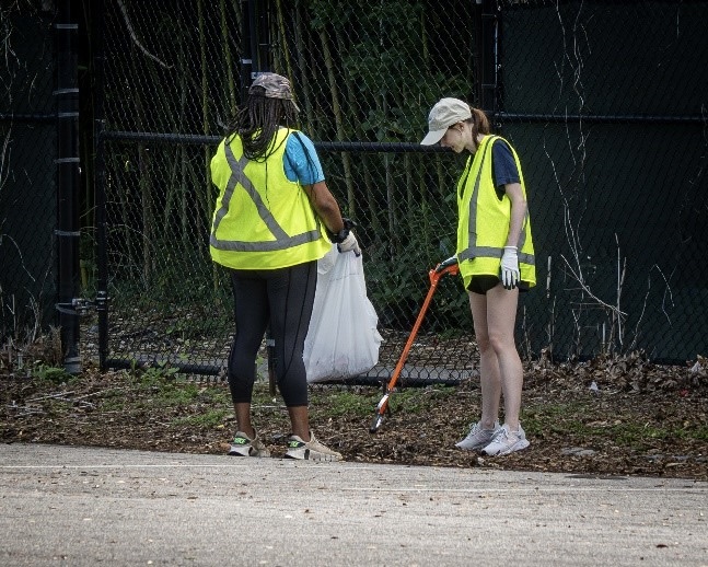A group of two volunteers picking up trash.